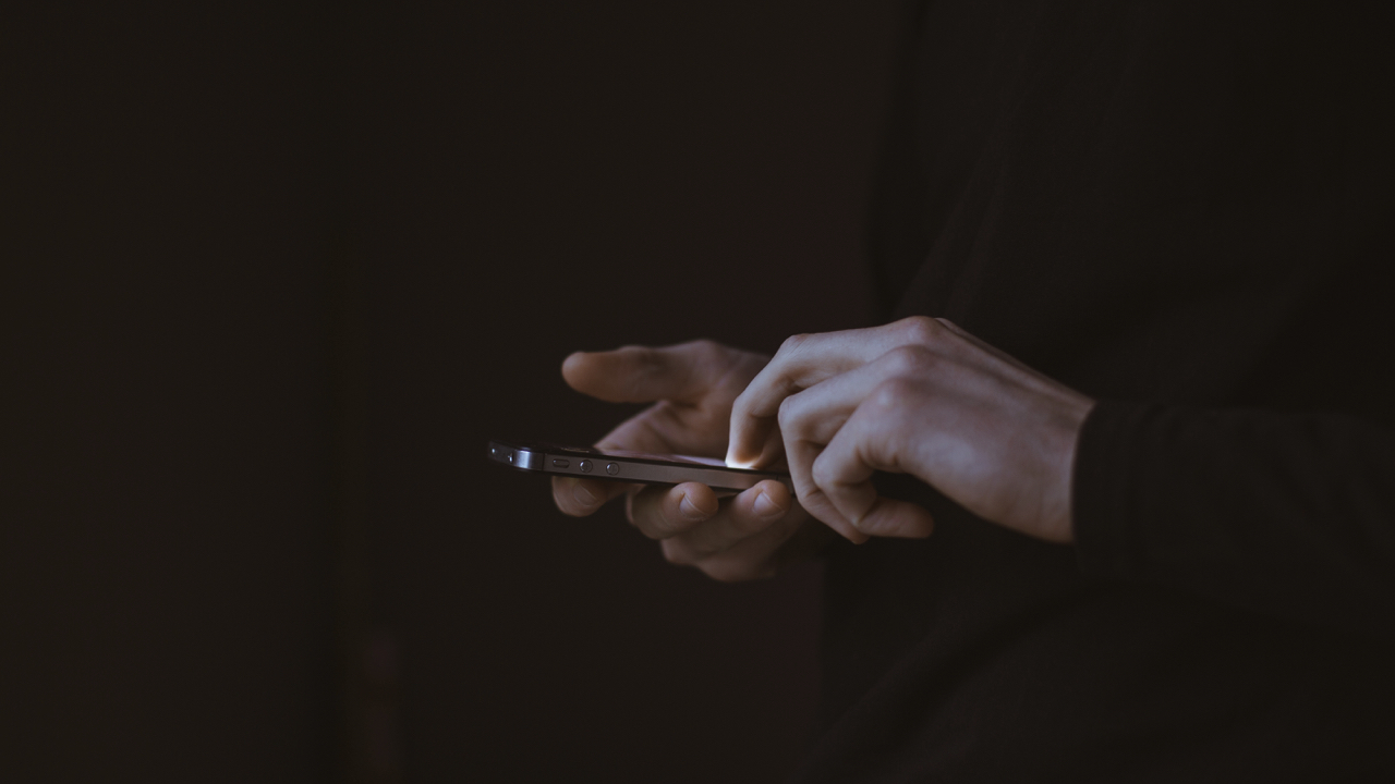 A man using an iPhone.